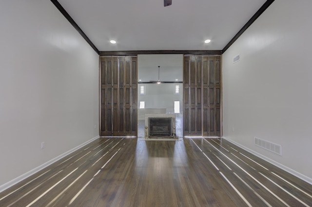 unfurnished living room with crown molding and dark hardwood / wood-style floors