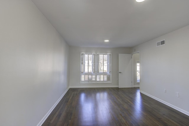 spare room featuring dark hardwood / wood-style flooring