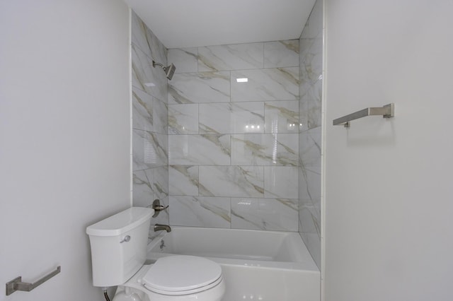 bathroom with tiled shower / bath combo and toilet