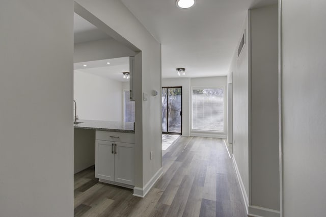 hallway with light hardwood / wood-style flooring