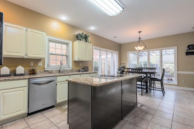 kitchen featuring dishwasher, a center island, light stone countertops, black electric cooktop, and decorative light fixtures