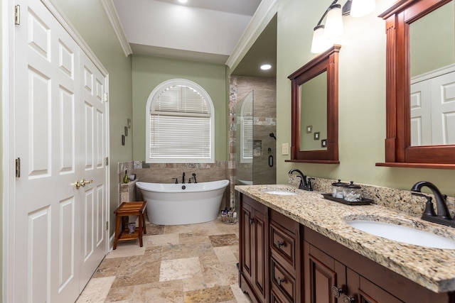 bathroom featuring vanity, ornamental molding, and shower with separate bathtub