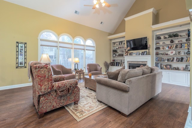 living room featuring built in shelves, dark wood-type flooring, high vaulted ceiling, and ceiling fan