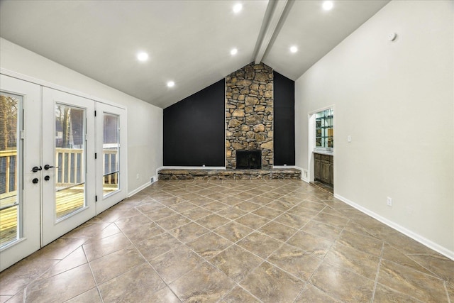 unfurnished living room featuring beamed ceiling, a stone fireplace, high vaulted ceiling, and french doors