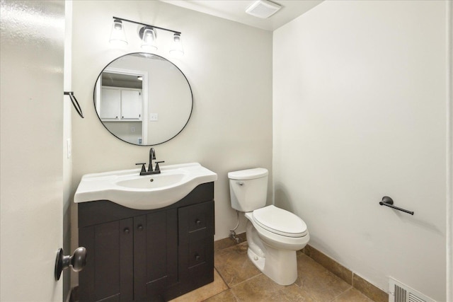 bathroom featuring tile patterned floors, vanity, and toilet