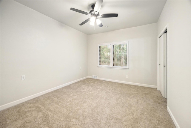 unfurnished room with ceiling fan and light colored carpet