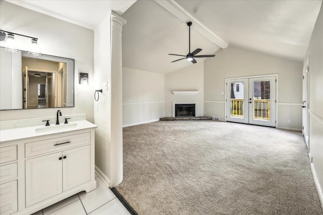 bathroom with ceiling fan, beam ceiling, high vaulted ceiling, vanity, and french doors