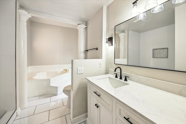 bathroom with vanity, a relaxing tiled tub, tile patterned floors, and toilet