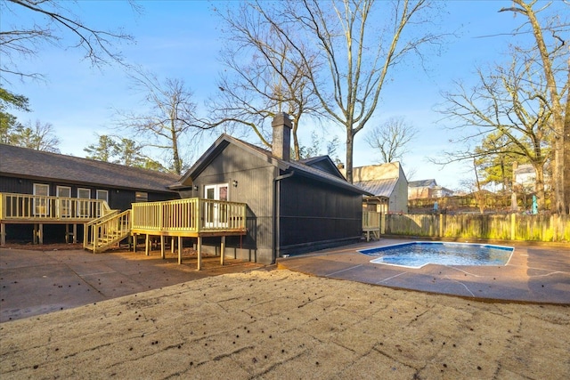 view of swimming pool featuring a patio and a deck