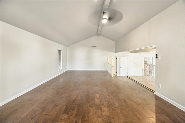 unfurnished living room featuring dark wood-type flooring, ceiling fan, and beamed ceiling