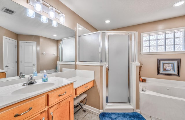 bathroom featuring tile patterned flooring, vanity, and separate shower and tub