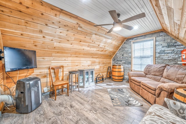 living room with wood ceiling, ceiling fan, wooden walls, wood-type flooring, and vaulted ceiling