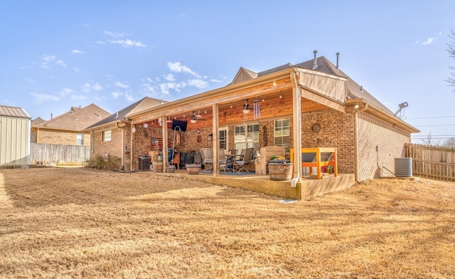 rear view of property with central AC, a patio, ceiling fan, and a lawn