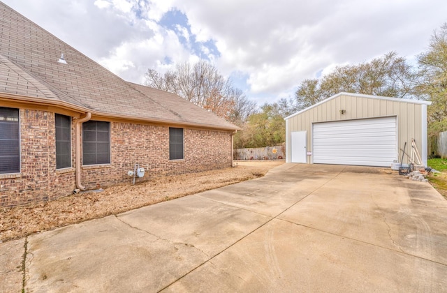 view of side of property with a garage and an outdoor structure