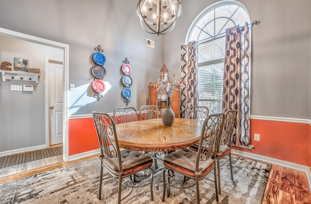 dining area featuring a chandelier and light hardwood / wood-style flooring