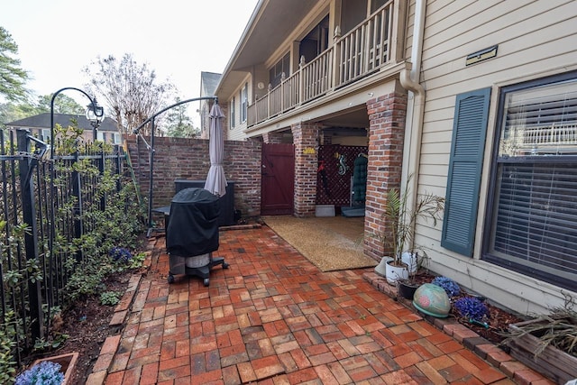 view of patio / terrace with a balcony and a grill