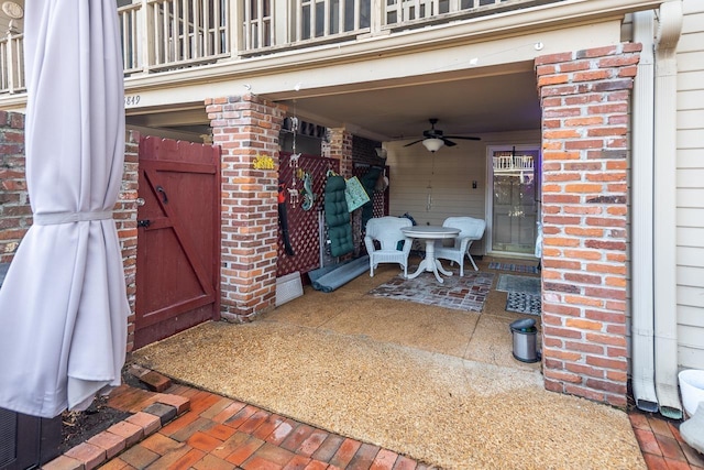 view of patio / terrace with ceiling fan and a balcony