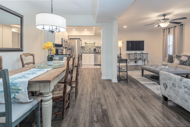 dining space featuring ceiling fan and dark hardwood / wood-style flooring