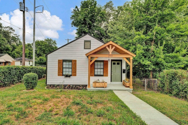 bungalow-style home with a front lawn