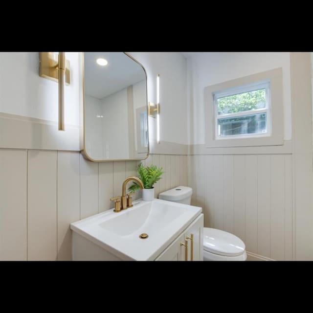 bathroom featuring vanity and toilet