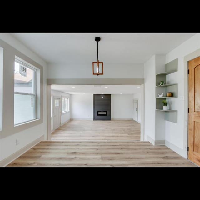 unfurnished living room featuring light wood-type flooring