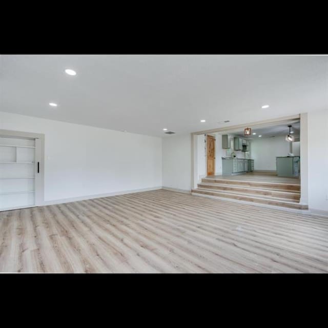 unfurnished living room with light hardwood / wood-style flooring