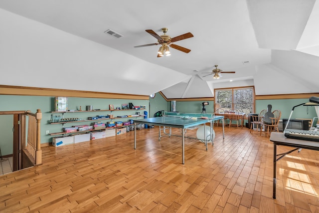 recreation room featuring lofted ceiling, ceiling fan, and light wood-type flooring