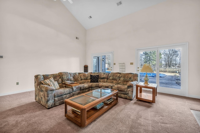 living room featuring high vaulted ceiling, carpet floors, and a wealth of natural light