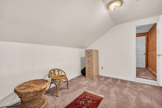 living area featuring lofted ceiling and light colored carpet