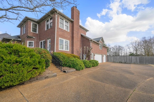 view of side of home featuring a garage