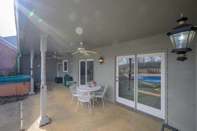 view of patio / terrace featuring ceiling fan and a hot tub