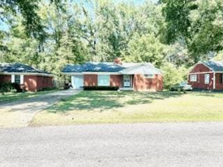 single story home featuring a garage and a front lawn