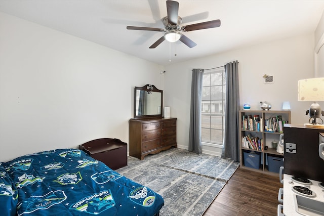 bedroom with dark wood-type flooring and ceiling fan