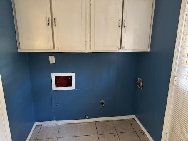 laundry room with light tile patterned floors, hookup for a gas dryer, hookup for a washing machine, and cabinets