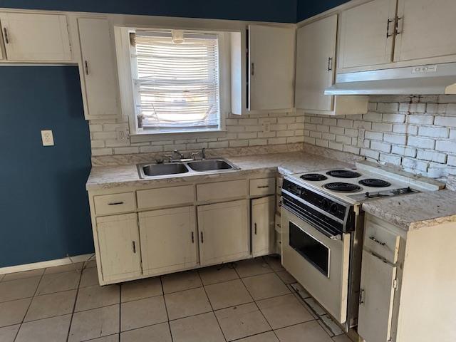 kitchen featuring white cabinetry, white electric range, and sink