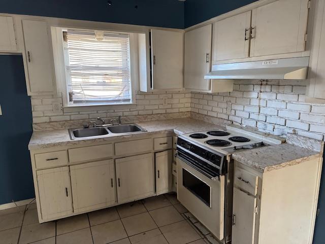 kitchen featuring white cabinetry, sink, and electric range