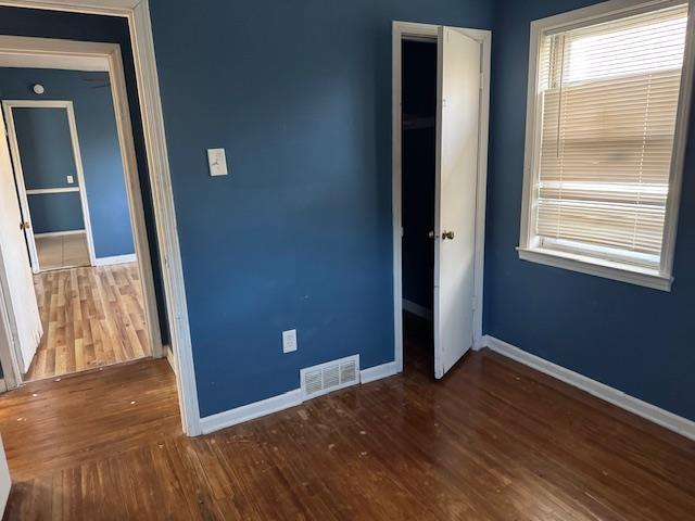 unfurnished bedroom featuring hardwood / wood-style flooring