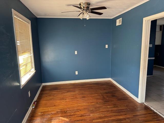 spare room with ceiling fan, ornamental molding, and hardwood / wood-style floors