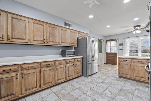 kitchen with ceiling fan and appliances with stainless steel finishes