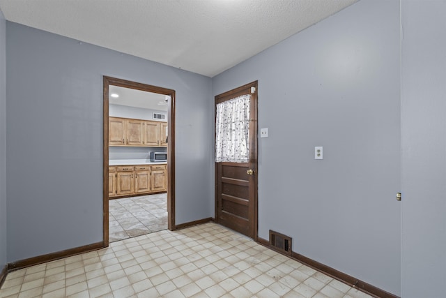 entryway with a textured ceiling