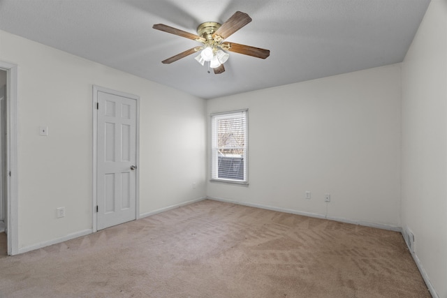 unfurnished room with light carpet and ceiling fan