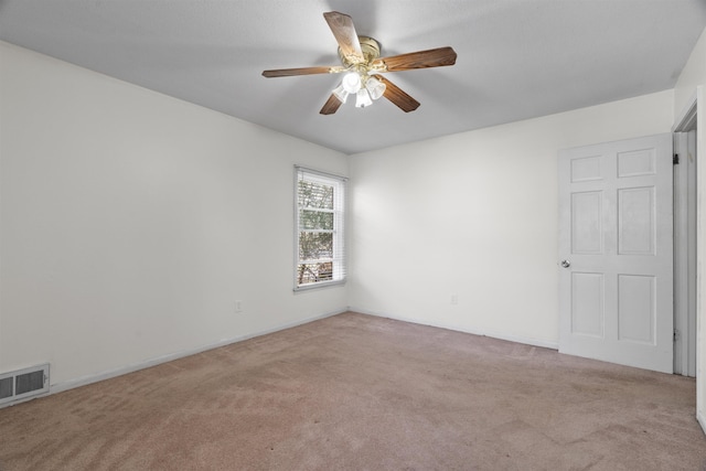 spare room featuring ceiling fan and light colored carpet