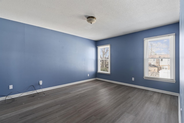 unfurnished room featuring a textured ceiling and dark hardwood / wood-style flooring