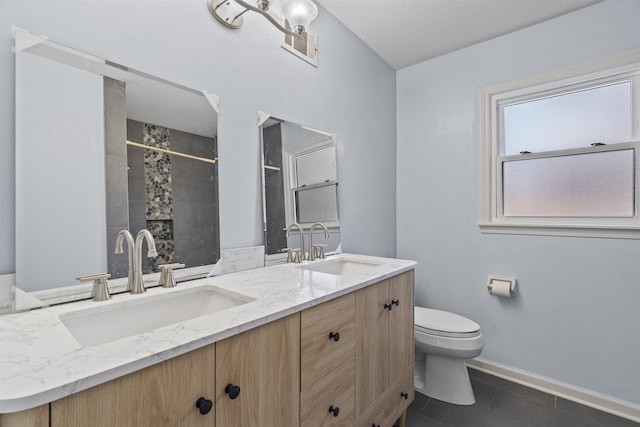 bathroom with vanity, tile patterned floors, and toilet