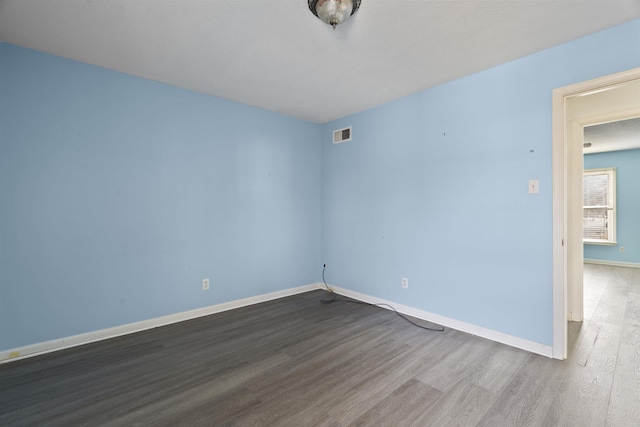 unfurnished room featuring hardwood / wood-style flooring