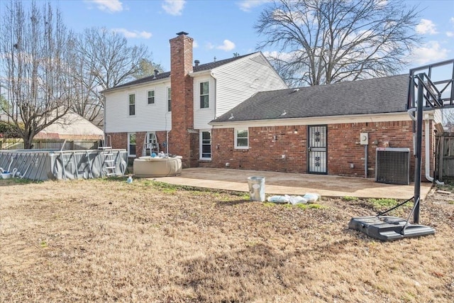 rear view of property featuring a patio and cooling unit