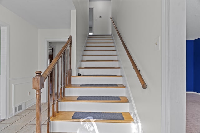 stairs with tile patterned floors