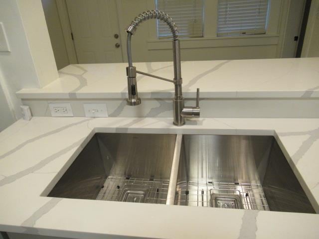 room details featuring sink and light stone countertops