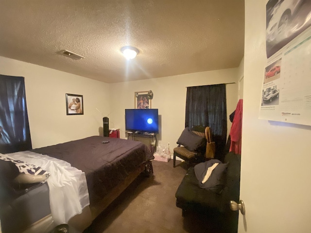 carpeted bedroom with a textured ceiling