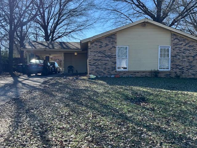 view of property exterior with a carport